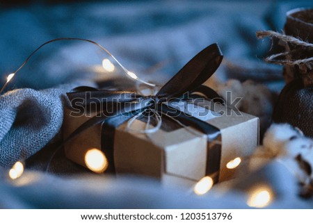 Cozy winter composition with eco gifts and christmas lights, flat lay, mock up, macro photo