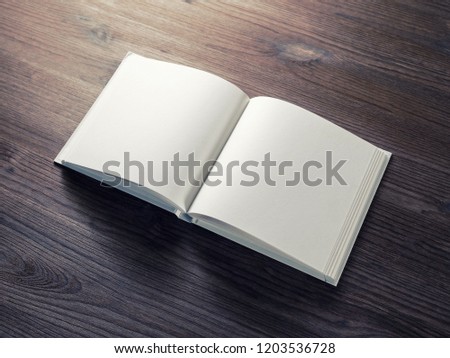Photo of blank opened brochure on wooden background. Template for graphic designers portfolios.