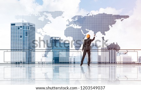 Young engineer in suit at balcony against morning cityscape background
