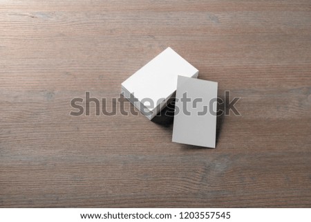 Mockup of blank business cards at wood table background.