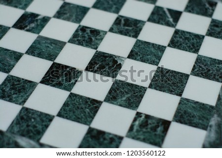 Marble chessboard closeup background texture.