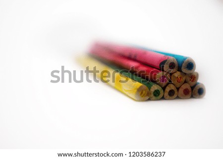 colorful pencils are not sharpened and lie on the table. These colors can draw festive pictures