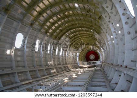 empty airplane airframe / fuselage without any equipment and no panels installed Royalty-Free Stock Photo #1203597244