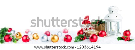 Christmas lantern with gifts, colored balls and Santa Claus on snow isolated background. Christmas background concept