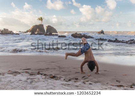 Boy having fun at Tambaba beach in Paraíba, Brazil.