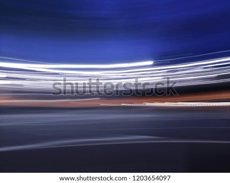 Abstract background of bright colorful lines with feeling of movement or motion in a dusk evening blue environment