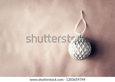 White and silver Christmas baubles decoration on bright background. Flat lay. Holiday concept.