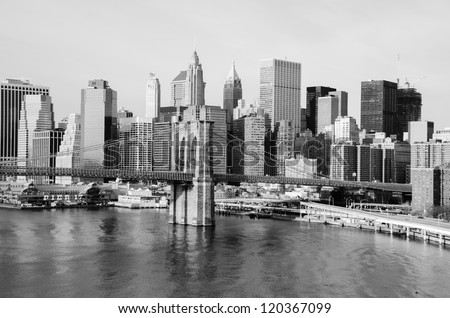 New York City skyline with Brooklyn Bridge and Lower Manhattan view in early morning sun light - Black and white