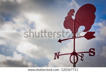 Weather cock against a cloudy sky Royalty-Free Stock Photo #120367711