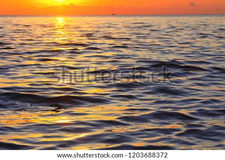 Water ripple on the sea during golden sunset