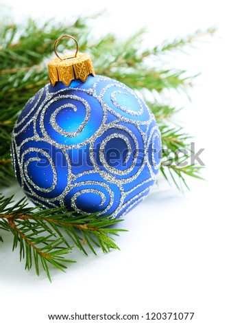 Fir branch and blue christmas ornament isolated on white background
