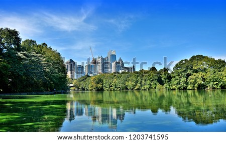 Atlanta skyline reflects in Lake Clara Meer in Piedmont Park. Atlanta. Georgia.