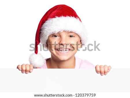 Portrait of happy little boy in Santa hat with white blank