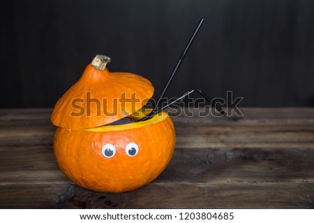 cocktail in a decorated pumpkin. halloween drinks for party