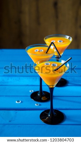 funny and scary cocktail for halloween in high martini glasses
