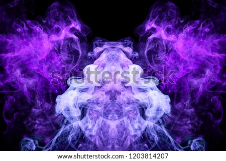 Mocap for cool t-shirts. Dense multicolored smoke of   purple and blue  colors in the form of a skull, monster, dragon  on a black isolated background. 