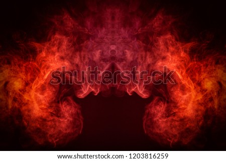 Mocap for cool t-shirts. Cloud of red and pink smoke in the form of a skull, monster, dragon on a black isolated background. Background from the smoke of vape