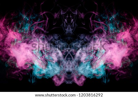 Fantasy print for clothes: t-shirts, sweatshirts.  Colorful pink and blue smoke in the form of a skull, monster, dragon on a black isolated background. Background from the smoke of vape
