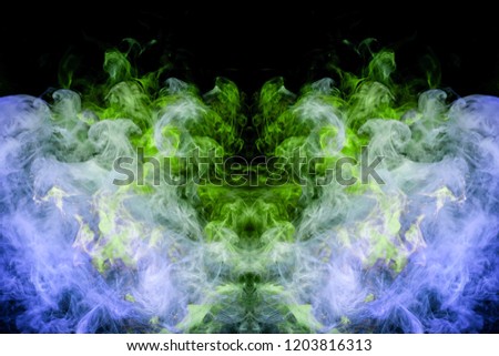 Mocap for cool t-shirts. Dense multicolored smoke of   blue and green colors in the form of a skull, monster, dragon  on a black isolated background. 