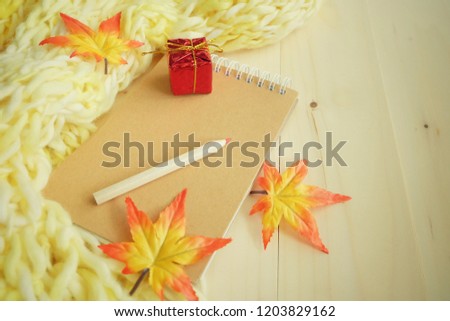 Diary and scarf on wooden table