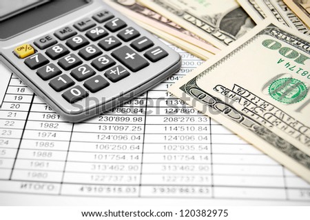 Calculator and money on the documents.