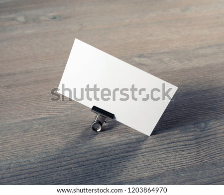 Photo of blank business card on wooden background. Mock-up for branding identity.