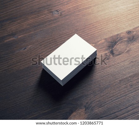Photo of blank business cards on vintage wood table background. Template for ID. Mock-up for branding identity.