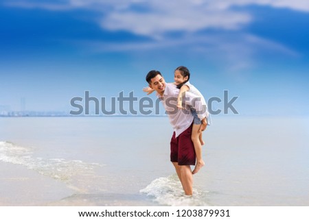 Family on the beach.happy family holiday travel summer.father and daugter are resting on the beach.relaxing by the sea