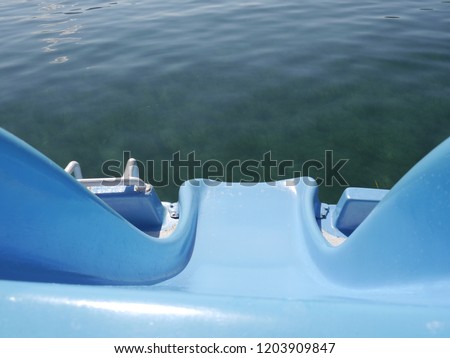 Blue plastic slide to sea water surface under the bright sun