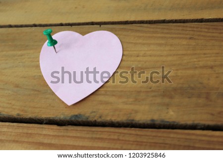 Heart shaped sticky notes on a wooden  background