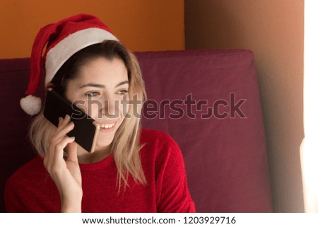 Happy teenage girl with the phone at Christmas
