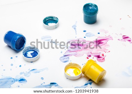 splashes of watercolor paint and painting supplies  close up