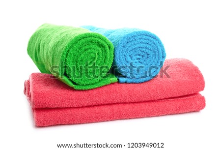 Stack of bright towels on white background