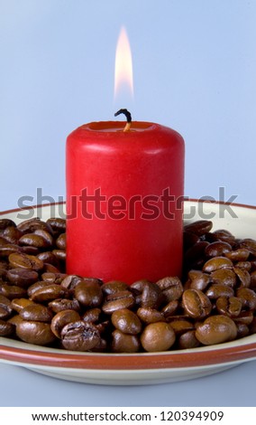 burning candle and coffee beans