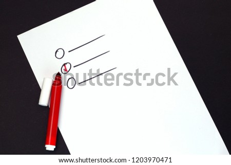 To do list concept. Check list on white paper and red marker on black desktop background. 
Top view of red marker on white paper on black desktop background. 
Hand drawn check list.
