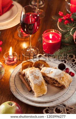 Traditional puff pastry strudel with apple, raisins and cinnamon. Christmas table