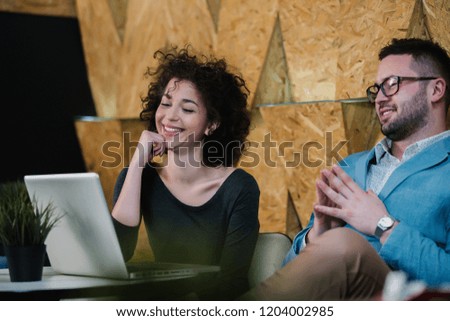 The guy and the woman are happy to watch the work on the laptop