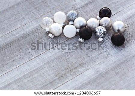 Black, White And Silver Christmas Balls On Wooden Background, Winter Holiday Concept