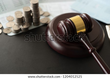 gavel judge with money coin on book bank. banking and finance law.