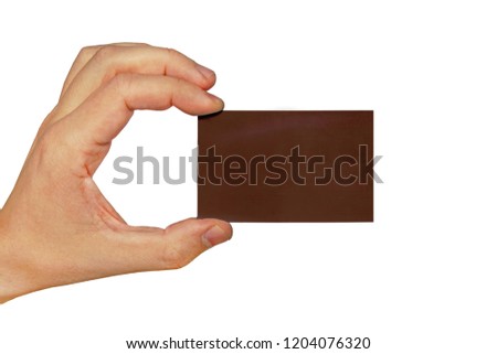 Hand holding a business card isolated on white background. Dark brown business card in male hand isolated on white background
