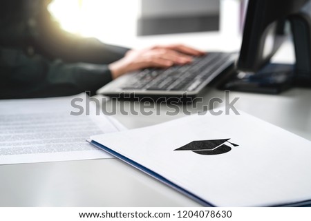 Student writing college or university application. Apply to school. Admission or grant. Teacher and computer. Principal or headmaster working in office. Politician, minister or secretary of education. Royalty-Free Stock Photo #1204078630