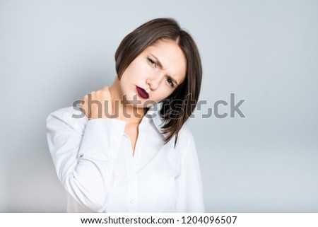 Closeup of business woman with neck pain, short hair cutting, isolated over gray background
