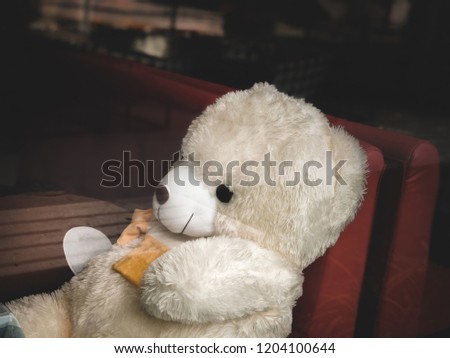 Teddy bear sitting alone in restaurants