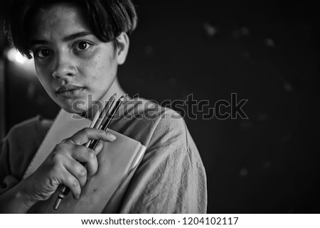 adult girl draws on paper pencils / portrait of a beautiful young female student, art school education, concept of art education