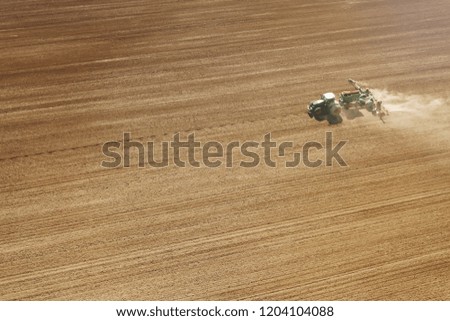 Aerial Tractor sowing crops at field
