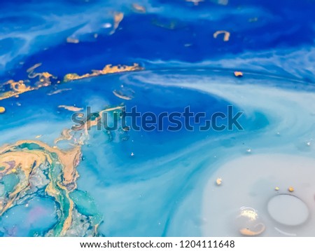 Abstract colorful bubbles marble background with milk oil and soap. Colored acrylic react to a drop of liquid soap in the oil. Christmas background.