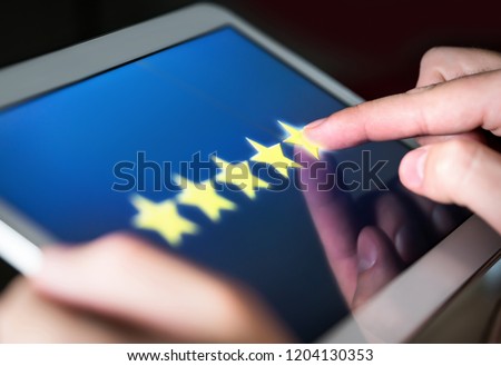 5 star rating or review in survey, poll, questionnaire or customer satisfaction research. Happy man giving positive feedback with tablet. Successful business with good reputation. Good experience. Royalty-Free Stock Photo #1204130353