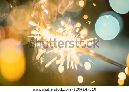 Sparkler Bokeh Colorful sparkler. Night background with a sparkler. 