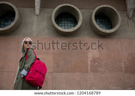 Young woman with backpack in city
