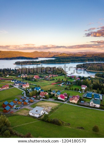 Sunset over Solina lake and Polanczyk village in Bieszczady mountains in Poland. Aerial photography.